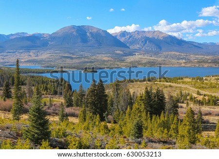 Looking out towards Lake Dillon and the Gore Range beyond from Swan Mountain in Summit County, Colorado on a clear summer day. Royalty-Free Stock Photo #630053213