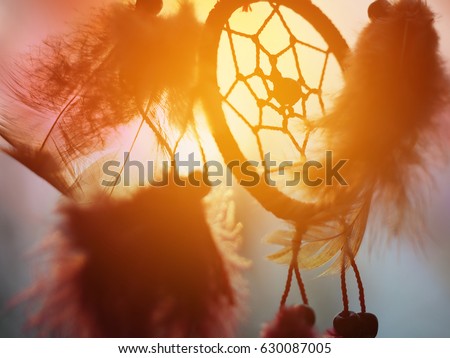 Dream catcher in the wind and blurred sun light background, native american
