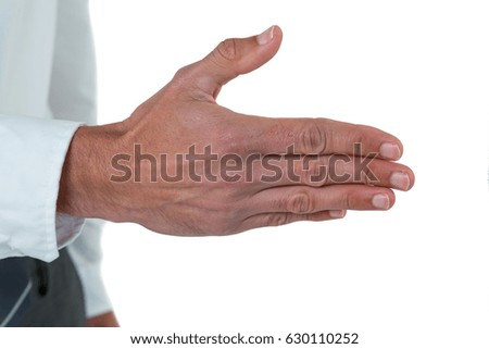 Mid section of executive his hand for offering handshake against white background