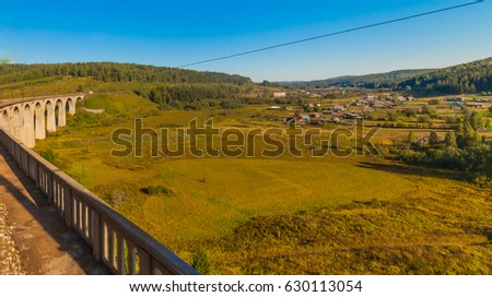 Summer landscape with a railway bridge