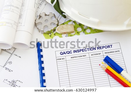 Inspection report abstract with engineering tools and hard hat.