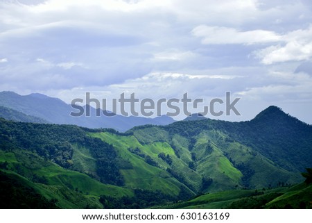 Big green mountains with clouds