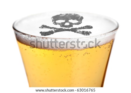 The dangers of alcoholism concept with a skull and cross bones symbol floating on top of the beer. Shallow depth of field.
