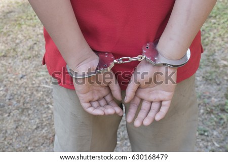 boy hands in handcuffs. no freedom Royalty-Free Stock Photo #630168479