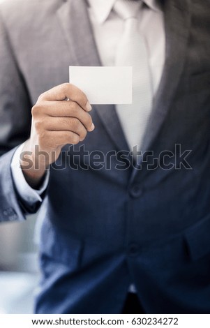 Business man holding white business card