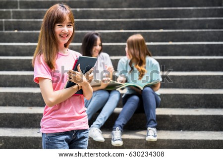 group of happy teen high school students outdoors