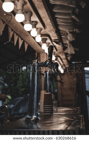 Street Cafe. Beer faucet on the counter. Evening