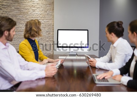 Business team looking at computer screen in the meeting room at office