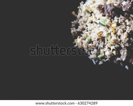 This is pork fried rice on black background, isolated,  soft tone
