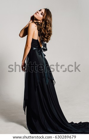Individuality. Thoughtful Elegant Lady in Black Prom Evening Dress.  
