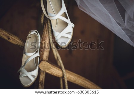 White bridal shoes and wooden branch