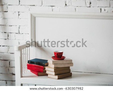Set of the old books with the red cup