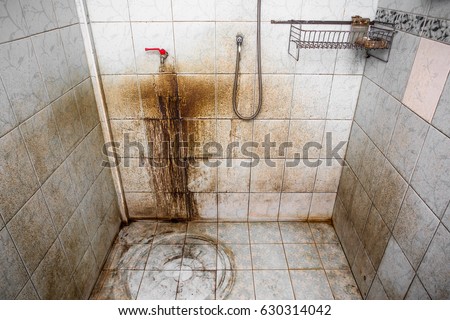 red water tap and shower tap pipe line with very heavy nasty stains dirty washroom environment lot of muddy black mold Royalty-Free Stock Photo #630314042