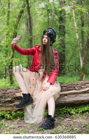 Girl in red leather jacket makes selfie