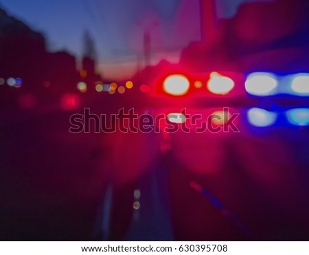Red and blue Lights of police car in night time. Night patrolling the city. Abstract blurry image. Royalty-Free Stock Photo #630395708