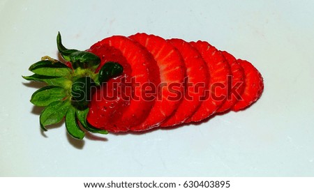 Strawberry on a white plate. Berry sliced horizontal. 