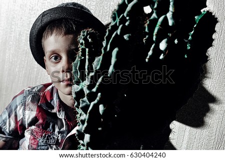 Portrait with a boy and green cactus
