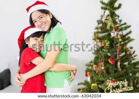 Asian mother and daughter on Christmas, hug each other