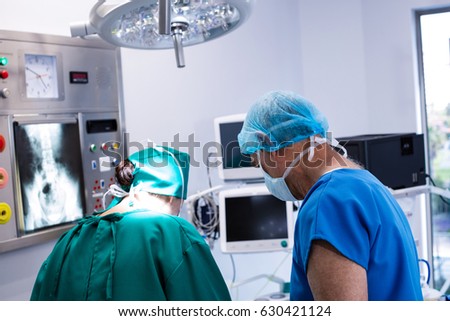 Male and female surgeon working in operation theater of hospital. Healthcare workers in the Coronavirus Covid19 pandemic

