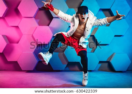 Man hip-hop street dancer in colored freak clothes Royalty-Free Stock Photo #630422339