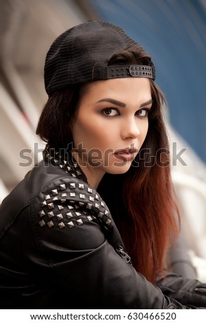 fashionable young teenager girl with ombre colored hair walking on the street wearing rock clothes leather biker jacket