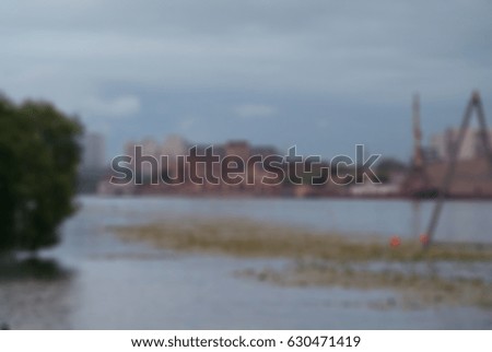Blurred background- people active days on the river. Wake boarding - water sport to strengthen the body.