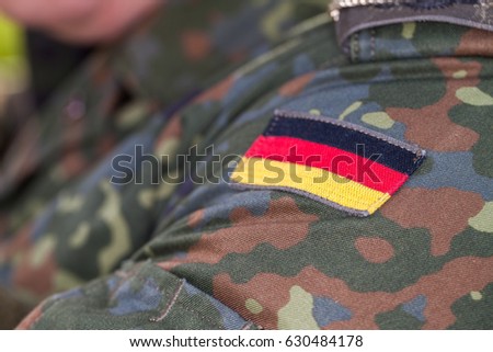 german flag on german army uniform Royalty-Free Stock Photo #630484178