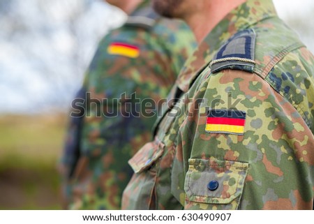 german flag on german army uniform Royalty-Free Stock Photo #630490907