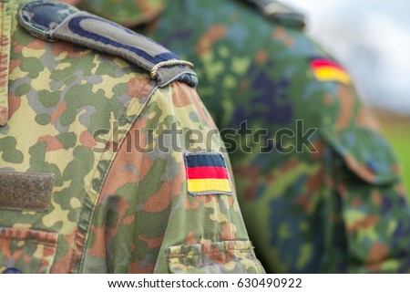 german flag on german army uniform Royalty-Free Stock Photo #630490922