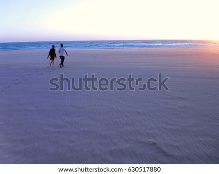 person jogging on the beach at sunset 