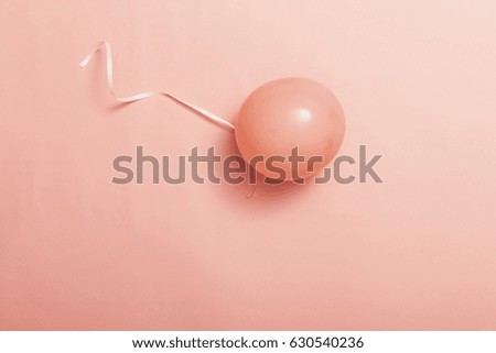 a pink balloon on the pink background.