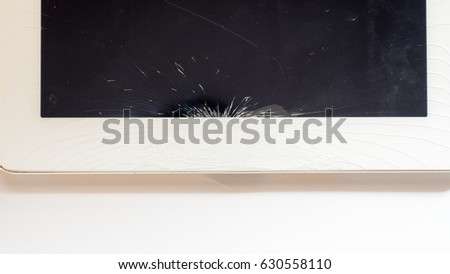 tablet computer with broken glass screen isolated on white background