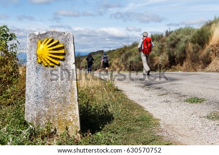 The yellow scallop shell signing the way to santiago de compostela on the st james pilgrimage route Royalty-Free Stock Photo #630570752