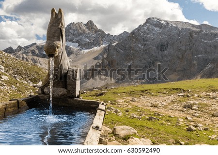 Water spring on Alps mountains background Dolomites
