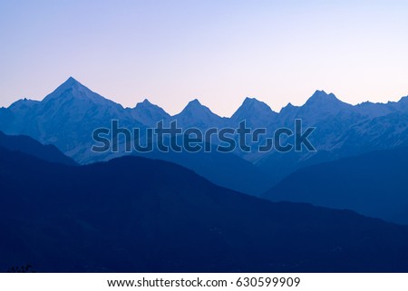 Mountain silhouette of Panchchuli peaks during sunrise in great Himalayan mountain range from Khalia bugyal at small hamlet Munsiyari, Kumaon region, Uttarakhand, India.