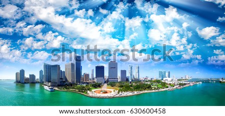 Panoramic aerial view of Miami Downtown at sunset. Buildings and ocean.