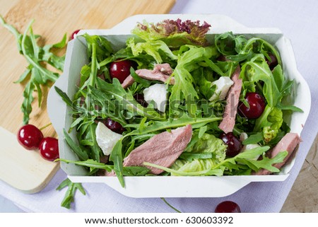 Beef, arugula and cherry salad in a  craft boxes.  Healthy concept. 