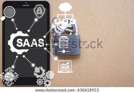SAAS (Software As A Service) Business Development Concept. Tablet Computer with cogwheel SaaS icon on virtual screen on background of network IT icons.