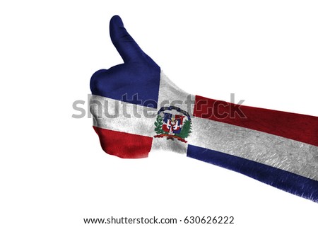 Hand making thumbs up sign. Dominican Republic painted with flag as symbol of thumbs like,up,okay. Isolated on white background.