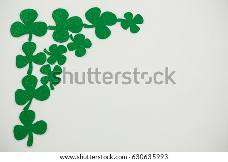 St Patricks Day shamrocks forming corner frame on white background