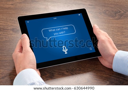 man hands holding tablet computer with app personal assistant on screen  Royalty-Free Stock Photo #630644990