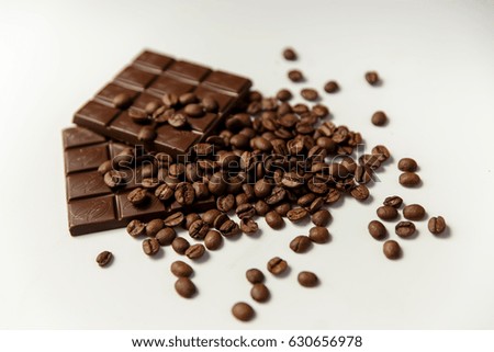 Picture of coffee beans and chocolate on a white background.