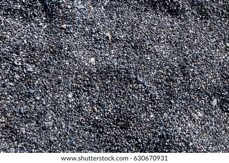 Abstract background of shallow sea, gray pebbles on the beach.