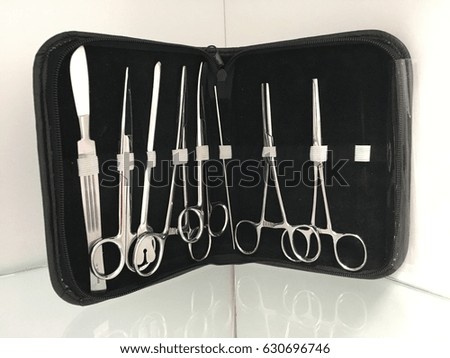 Surgical instrument kit on including hermostasts scissors holder needle probe and tweezers on an isolated background