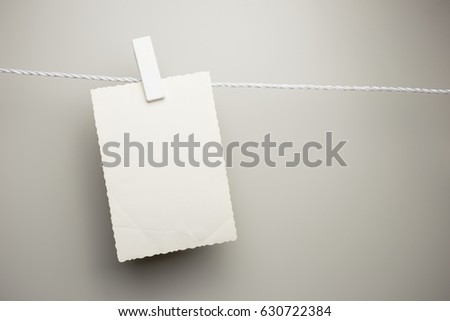 Vintage postcard hanging, isolated on gray