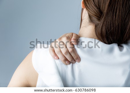 young woman having horribly stiff shoulders Royalty-Free Stock Photo #630786098