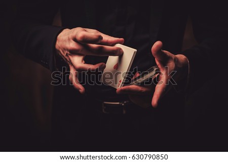 Man showing tricks with cards Royalty-Free Stock Photo #630790850