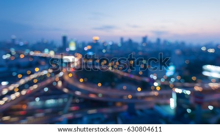 Top view blurred bokeh light city downtown and highway interchanged, abstract background