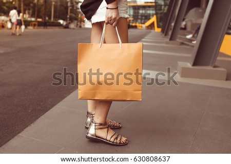 Woman walking with shopping bags with mall.