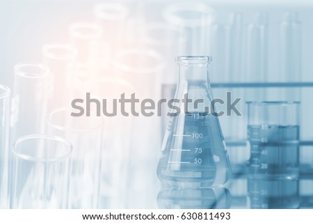Double exposure of equipment and science experiments ,Laboratory glassware containing chemical liquid, science research,science background and science concept. Royalty-Free Stock Photo #630811493